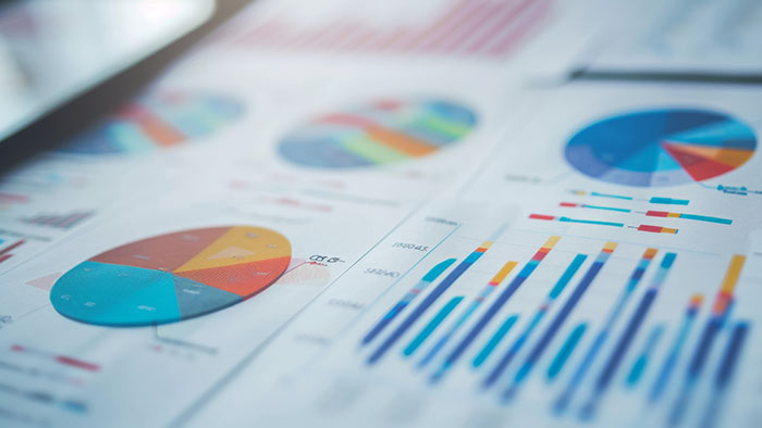 Colorful charts and graphs on paper, representing data analysis and visualization for data governance discussions