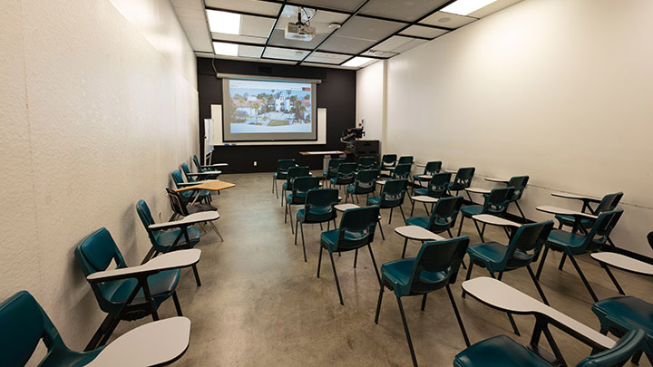 classroom with podium and projection screen in background