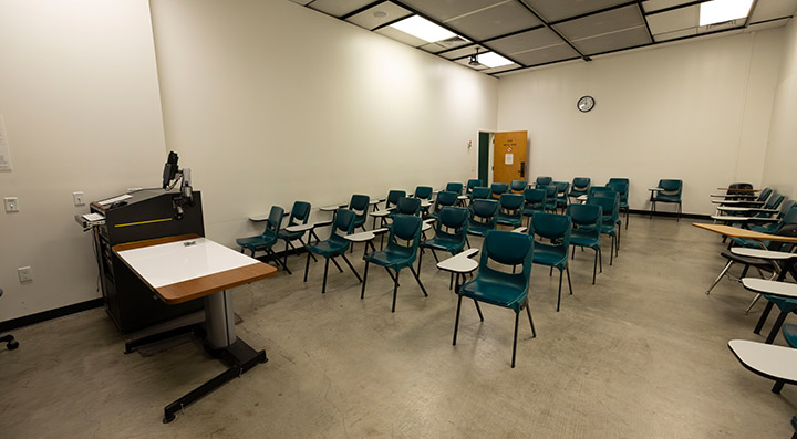 Front of classroom showing the podium and chairs