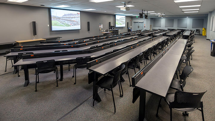 lecture hall with projection screens in background