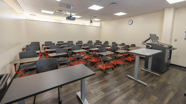 classroom view from the front, podium on right and projector in background