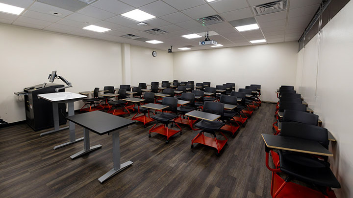 A view of classroom, instructor podium and projector