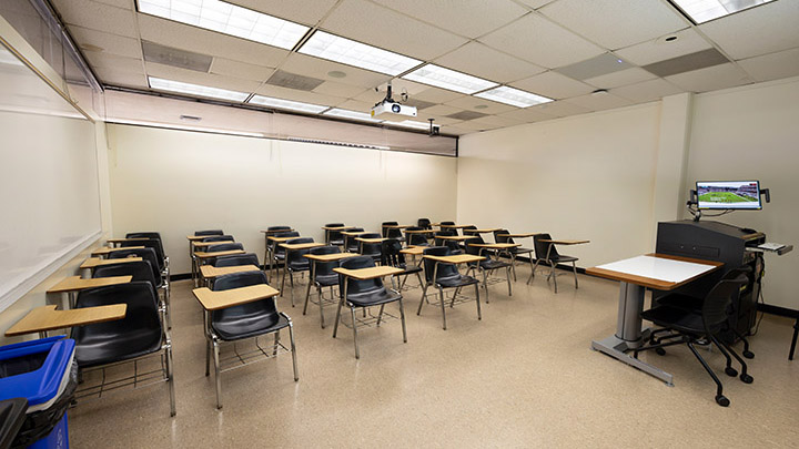 Adams Humanities 2116 view from front showing the podium and projector