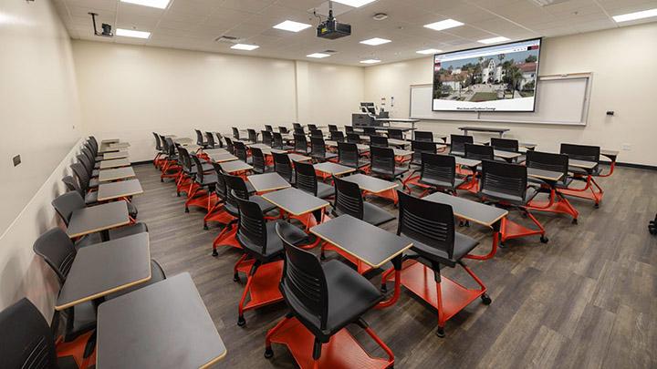 View from back of classroom showing the podium and projection screen