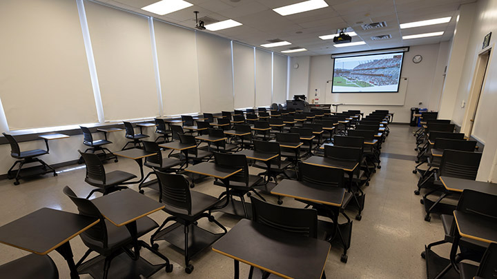 classroom with podium and projection screen in background