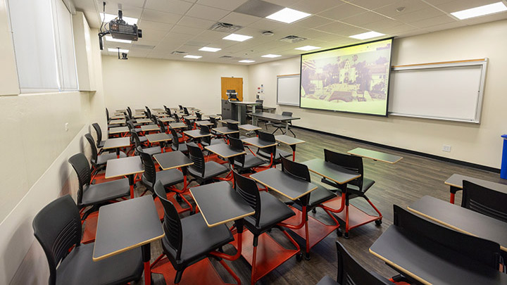 Classroom with podium, projector, and projection screen