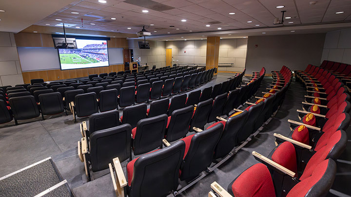 Classroom with stadium style seating, podium and projection screen