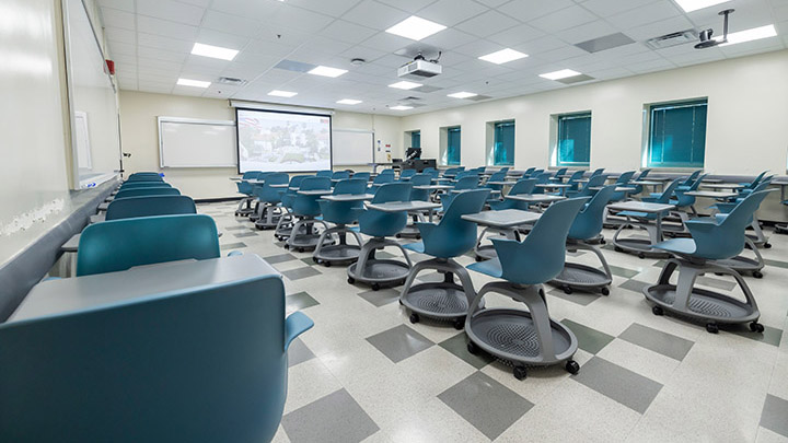 classroom with podium and projection screen in background