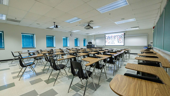 classroom with podium and projection screen in background