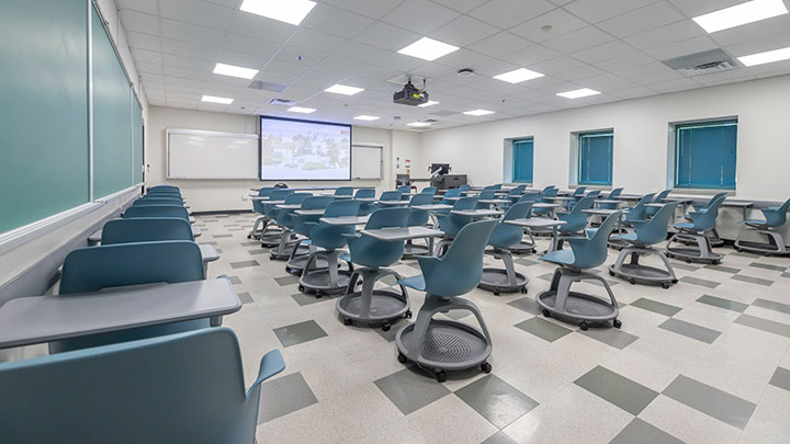 classroom with podium and projection screen in background