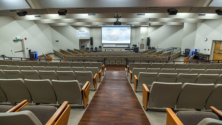 classroom with podium and projection screen in background