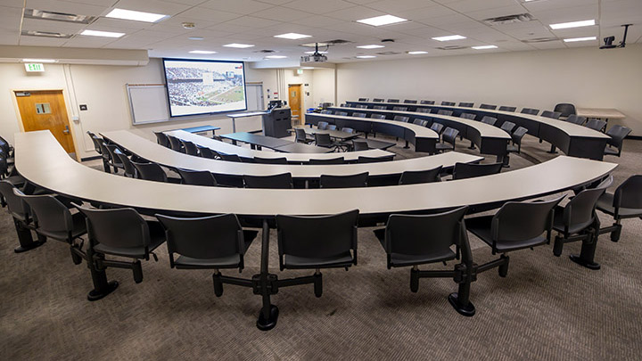 classroom with podium and projection screen in background