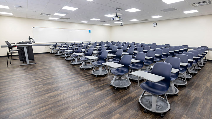 A view of Lamden Hall 347, showing instructor podium and projector.