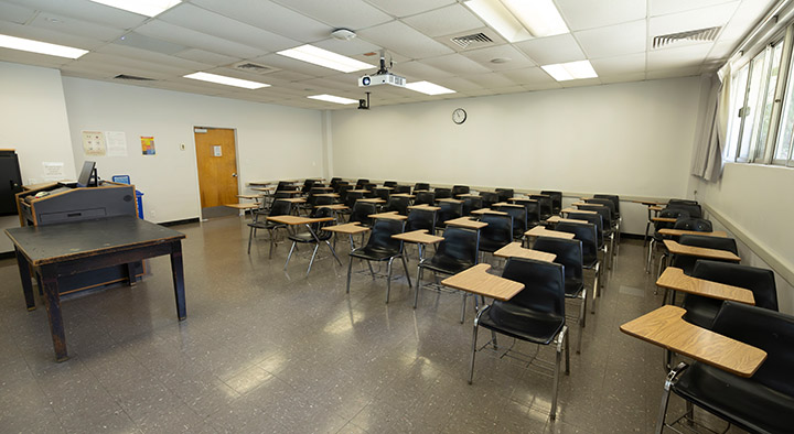 Front of classroom showing the podium and projector