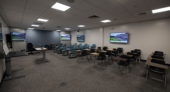 Front of classroom showing the podium and screens