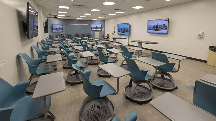 Classroom with seating and 5 screens on the walls