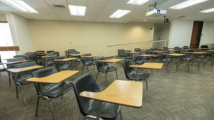 Front of classroom showing seating and projector