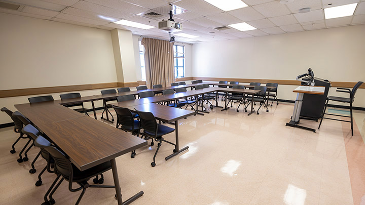 Front of classroom showing the podium and projector