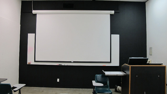 classroom with projection screen in background