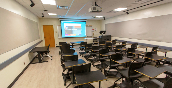 classroom with projection screen in background