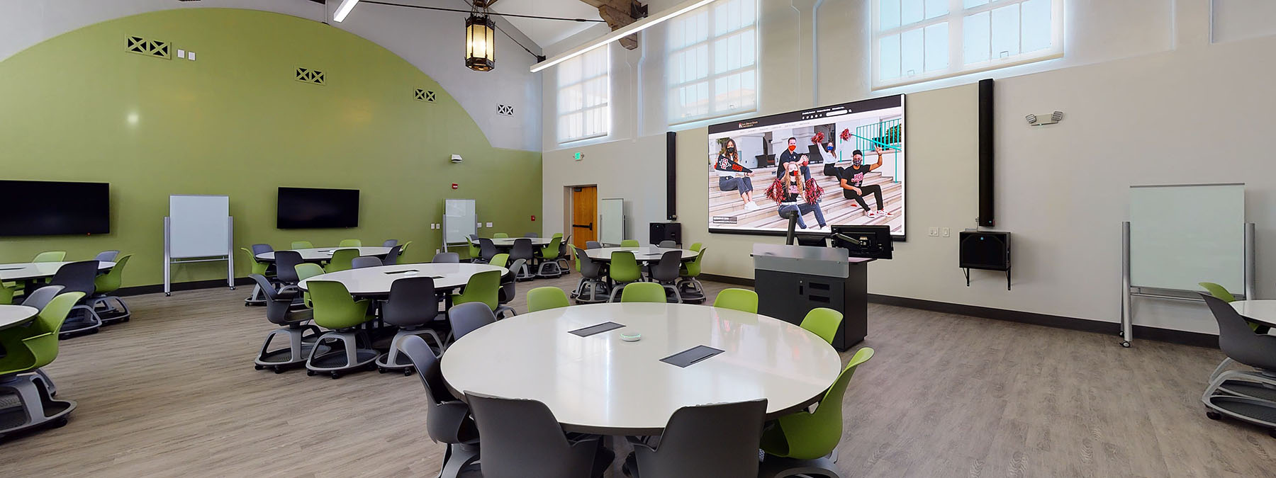Lecture hall PS 130, redesigned with large, circle tables for collaboration.