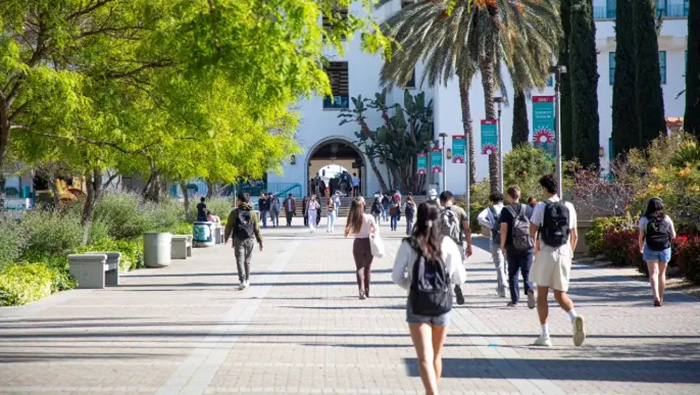 Students walk across SDSU’s campus toward the Student Union.