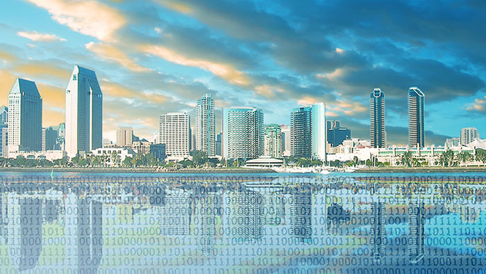 Illustration of the San Diego skyline with buildings reflected digitally, overlayed by binary code. Photo courtesy of the Cyber Center of Excellence.