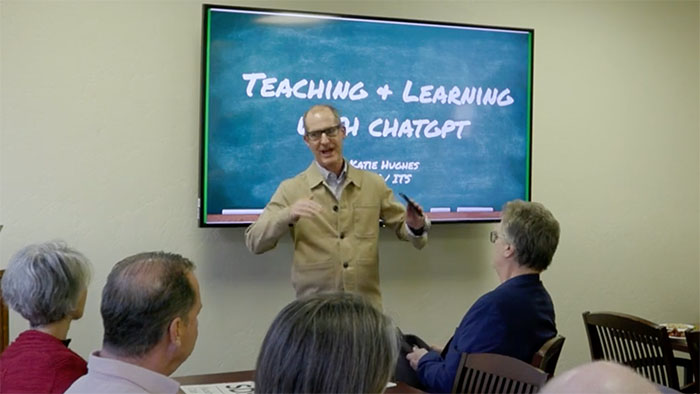 A faculty member leads a presentation on Teaching & Learning with ChatGPT