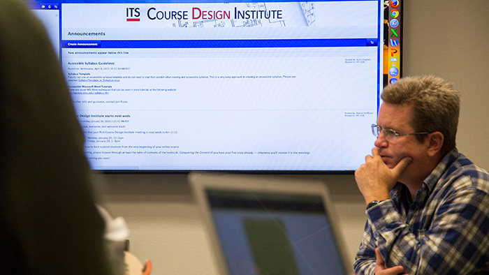 A participant in the Course Design Institute listens to a presentation